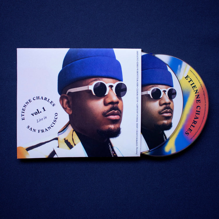 Etienne Charles & Creole soul live in san Francisco cd-one disc with charles face and one colorful disc